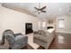 Comfortable living room featuring a fireplace, ceiling fan, comfortable seating, and lots of natural light at 2033 Buck Corner Ln, Fuquay Varina, NC 27526