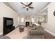 Comfortable living room featuring a fireplace, ceiling fan, comfortable seating, and lots of natural light at 2033 Buck Corner Ln, Fuquay Varina, NC 27526