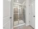 Modern bathroom with tiled shower, glass doors, and updated fixtures at 209 White Farm Dr, Wendell, NC 27591