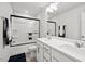 Well-lit bathroom with double sink vanity, framed mirror, and shower-tub combination at 209 White Farm Dr, Wendell, NC 27591