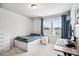 Bright bedroom offers a twin bed, a desk, and ample natural light from dual windows at 209 White Farm Dr, Wendell, NC 27591