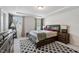 Spacious bedroom with decorative rug, tray ceiling, and dark wood furnishings at 209 White Farm Dr, Wendell, NC 27591