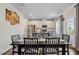 Dining area with a view of the kitchen, stainless steel appliances, and backyard through the back door at 209 White Farm Dr, Wendell, NC 27591