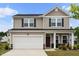Charming two-story home with a two-car garage and inviting front porch, with fresh landscaping at 209 White Farm Dr, Wendell, NC 27591