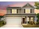 Charming two-story home with a two-car garage and inviting front porch, with fresh landscaping at 209 White Farm Dr, Wendell, NC 27591