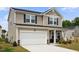 Charming two-story home with a two-car garage and inviting front porch, with fresh landscaping at 209 White Farm Dr, Wendell, NC 27591