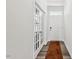 Hallway with natural light highlighting the french doors and modern flooring at 209 White Farm Dr, Wendell, NC 27591