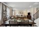Inviting open-concept living and dining area features hardwood floors and a cozy sectional sofa at 209 White Farm Dr, Wendell, NC 27591