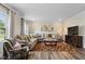 Bright living room features a large gray sectional, patterned rug, and media center at 209 White Farm Dr, Wendell, NC 27591