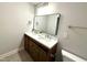 Bright bathroom featuring a dual sink vanity with modern fixtures and a framed mirror at 2107 Freeport Dr, Cary, NC 27519