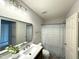 Bright bathroom featuring a dual sink vanity with modern fixtures and a framed mirror at 2107 Freeport Dr, Cary, NC 27519