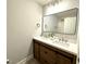Bright bathroom featuring a dual sink vanity with modern fixtures and a framed mirror at 2107 Freeport Dr, Cary, NC 27519