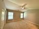 Bedroom featuring a ceiling fan, neutral paint, carpet, and windows at 2107 Freeport Dr, Cary, NC 27519