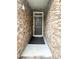 View of front door showing stone surround; entry area with welcome mat at 2107 Freeport Dr, Cary, NC 27519