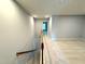 Second floor hallway featuring carpeting and natural light from the doors ahead at 2107 Freeport Dr, Cary, NC 27519