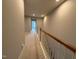 Second floor hallway featuring carpeting and natural light from the doors ahead at 2107 Freeport Dr, Cary, NC 27519