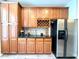 Kitchen cabinets with wine rack, counter top and stainless steel refrigerator at 2107 Freeport Dr, Cary, NC 27519