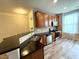 Open kitchen features stainless appliances, breakfast bar, tile backsplash and wood cabinets at 2107 Freeport Dr, Cary, NC 27519