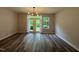 Spacious living room with hardwood floors, modern lighting and French doors leading to the yard at 2107 Freeport Dr, Cary, NC 27519