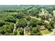 Aerial view of property nestled in trees; home sits on a lush golf course and the neighborhood has a community pool at 2190 Keith Hills Rd, Lillington, NC 27546