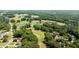 Drone eye view of golf course with beautiful ponds; ideal location for golfers and nature enthusiasts at 2190 Keith Hills Rd, Lillington, NC 27546