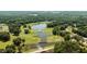 Aerial view of a golf course showing ponds, cart paths and greens; perfect for avid golfers and nature lovers at 2190 Keith Hills Rd, Lillington, NC 27546