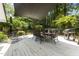 Spacious outdoor deck with a large dining table, barbecue grill, and shade covering, perfect for entertaining guests at 2190 Keith Hills Rd, Lillington, NC 27546