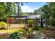Lush backyard featuring a swing set, playhouse, and stone pathway, creating an idyllic setting for outdoor enjoyment at 2190 Keith Hills Rd, Lillington, NC 27546