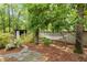 The serene backyard features a hammock strung between mature trees, offering a peaceful spot for relaxation and leisure at 2190 Keith Hills Rd, Lillington, NC 27546