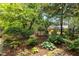 Lush backyard with verdant landscaping and guest house provides a private outdoor retreat, perfect for relaxation and entertainment at 2190 Keith Hills Rd, Lillington, NC 27546