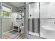 Stylish bathroom with patterned wallpaper, modern fixtures, and a glass-enclosed shower at 2190 Keith Hills Rd, Lillington, NC 27546