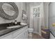 Stylish bathroom with patterned wallpaper, decorative mirror, and plenty of natural light at 2190 Keith Hills Rd, Lillington, NC 27546