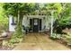 Charming cottage with lush greenery, a pergola, and swing for idyllic outdoor relaxation at 2190 Keith Hills Rd, Lillington, NC 27546