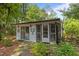 Charming exterior view of the home, showcasing the pristine white siding, complemented by meticulously landscaped greenery at 2190 Keith Hills Rd, Lillington, NC 27546
