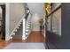 Foyer featuring hardwood floors, a staircase, and a decorated glass front door at 2190 Keith Hills Rd, Lillington, NC 27546