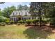 Charming white home with black shutters, dormer windows, and lush landscaping at 2190 Keith Hills Rd, Lillington, NC 27546