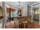 Bright eat in kitchen featuring wood floors, black countertops, an island and views to the living room at 2190 Keith Hills Rd, Lillington, NC 27546