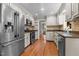 Well-lit kitchen features stainless steel appliances, wooden floors, and granite countertops at 2190 Keith Hills Rd, Lillington, NC 27546
