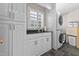 Laundry room with washer, dryer, storage, black granite countertops, and tile floors at 2190 Keith Hills Rd, Lillington, NC 27546