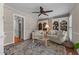 Comfortable living room with ceiling fan, built-in bookshelves, seating and a patterned rug at 2190 Keith Hills Rd, Lillington, NC 27546