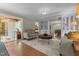Elegant living room with hardwood floors and adjacent sunroom and dining area at 2190 Keith Hills Rd, Lillington, NC 27546