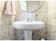 Elegant powder room with decorative wallpaper and pedestal sink at 2190 Keith Hills Rd, Lillington, NC 27546