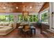 Bright sunroom with wood ceiling, brick floor, and dining table at 2190 Keith Hills Rd, Lillington, NC 27546