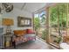 Bright sunroom with patterned sofa and view of landscaped backyard and provides a serene retreat for relaxation and enjoyment at 2190 Keith Hills Rd, Lillington, NC 27546