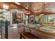 Inviting sunroom featuring wood ceilings, skylights, and brick floors at 2190 Keith Hills Rd, Lillington, NC 27546
