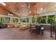 Cozy sunroom boasts natural lighting, brick floors, and comfortable seating at 2190 Keith Hills Rd, Lillington, NC 27546
