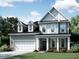 Charming two-story home showcasing a well-manicured lawn and classic architectural design at 2389 Picual Way # 23, New Hill, NC 27562