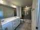 Bright bathroom features double sink vanity with white cabinets and walk-in shower at 239 Paramount Dr, Smithfield, NC 27577