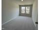 Neutral bedroom featuring carpet floors, a double window, and neutral-painted walls at 239 Paramount Dr, Smithfield, NC 27577