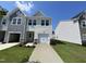 Charming two-story townhome featuring a one-car garage and a well-maintained front yard at 239 Paramount Dr, Smithfield, NC 27577